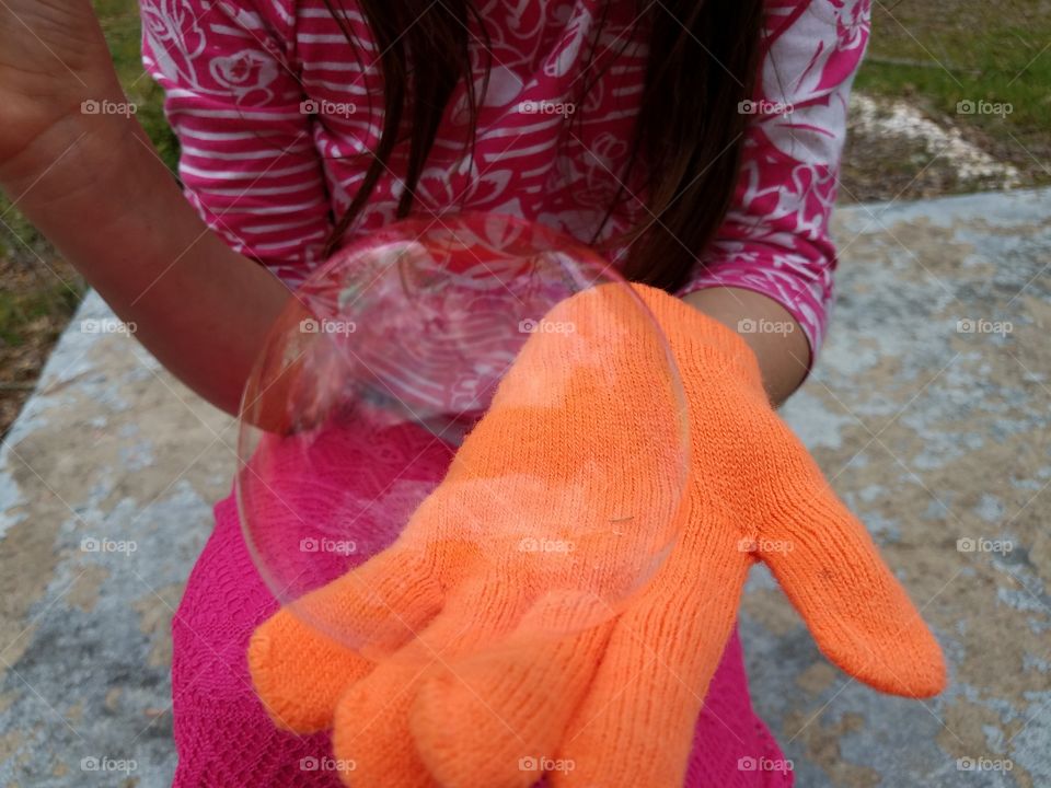 Girl's hand showing bubble