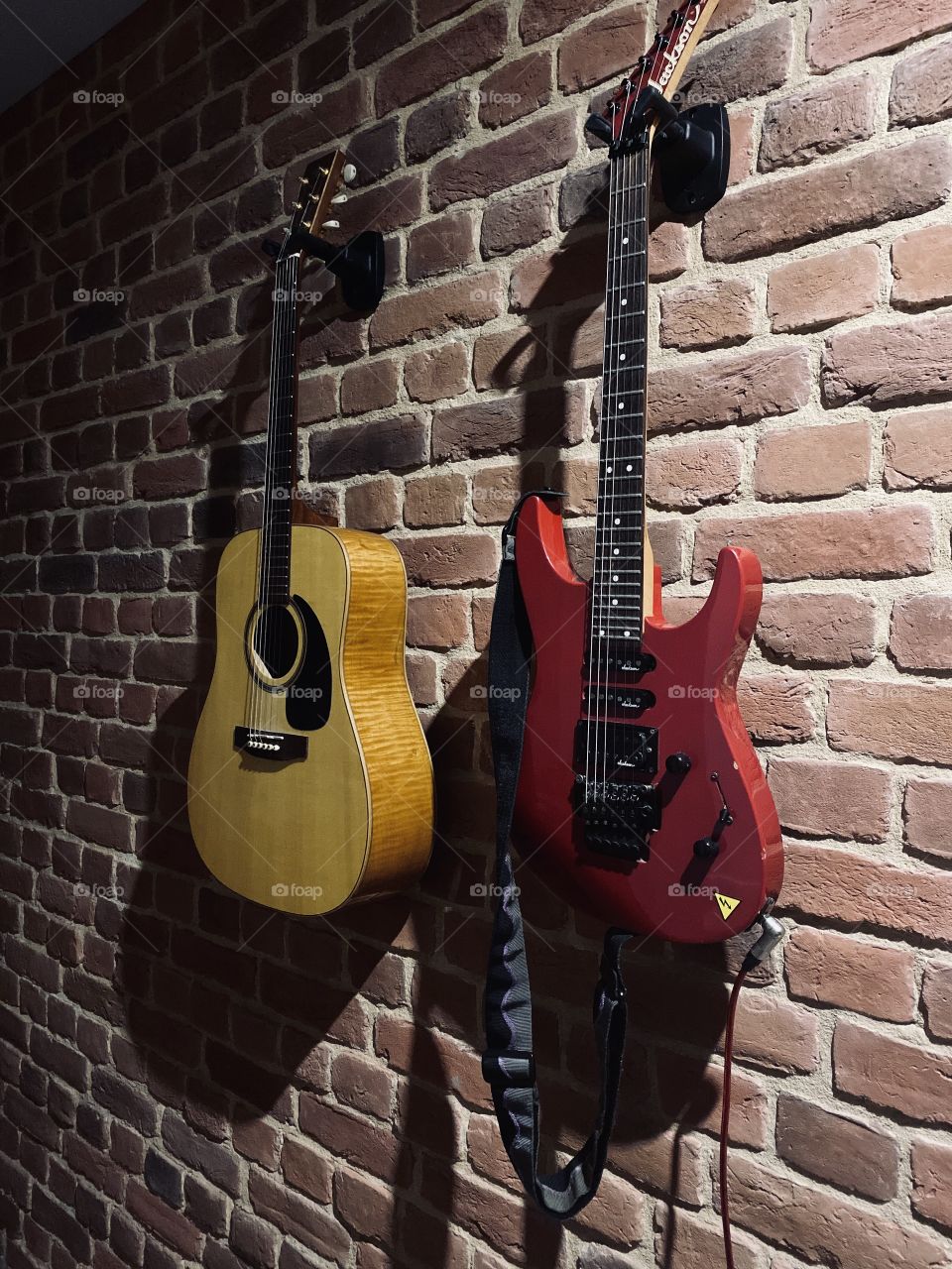 Guitars on brick wall
