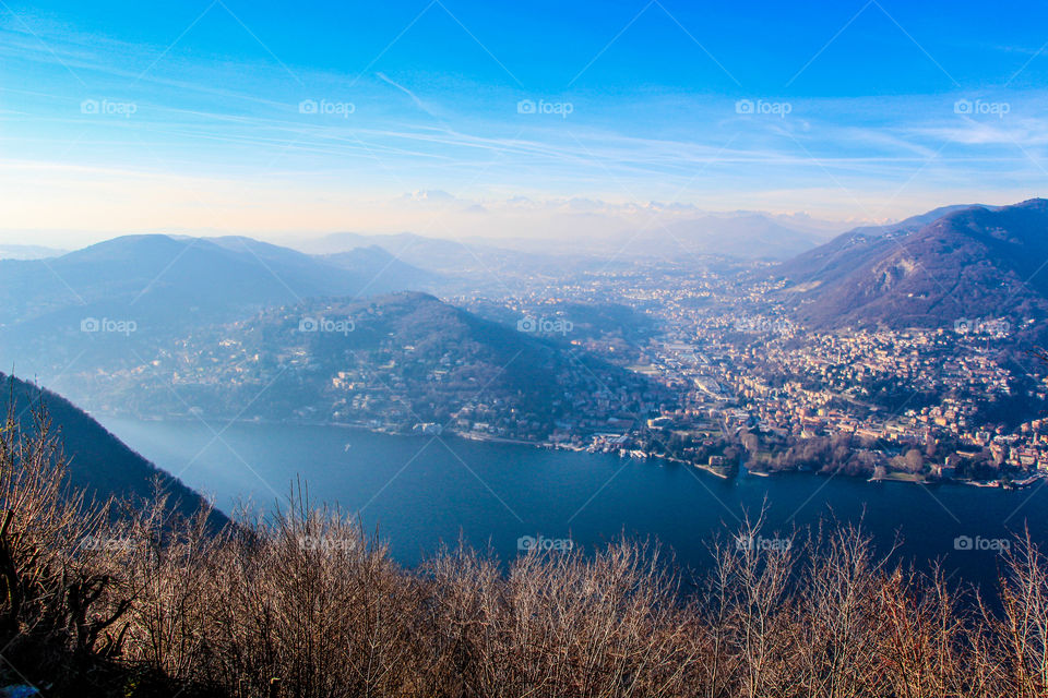Fog is everywhere. A high look over Lake Como in winter and cold days.