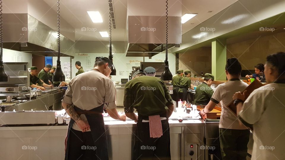 Chefs at work in the kitchen of Cuca restaurant in Bali, Indonesia