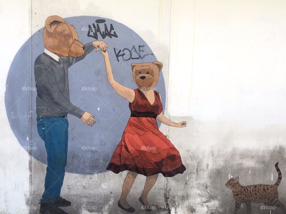 Mural of dancing bears in red dress with cat and graffiti 
