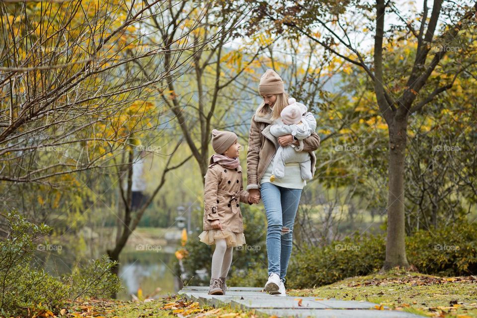 Family walking at autumnal park