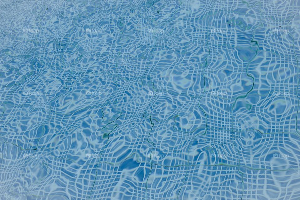 The texture of the wavy surface of the pool.  Blue background