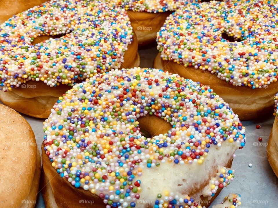 Yummy and delicious donuts glazed with colorful sprinkles 