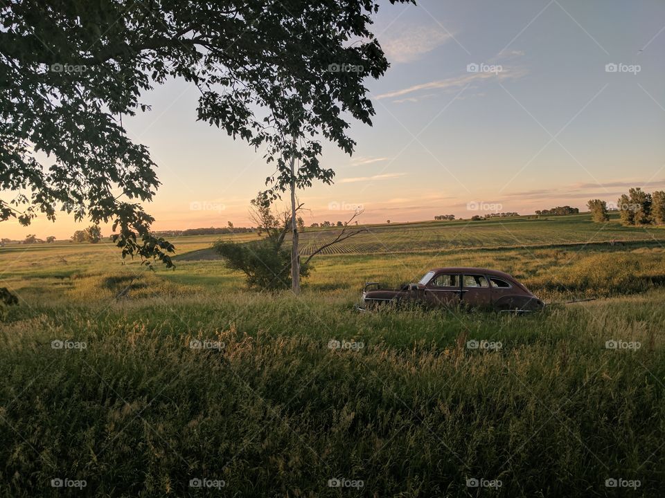 Sun set car in field