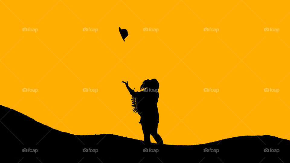 Lady throwing hat in the air yellow black color
