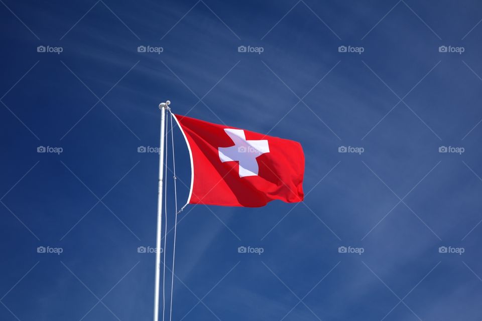 Swiss flag on the background of the sky
