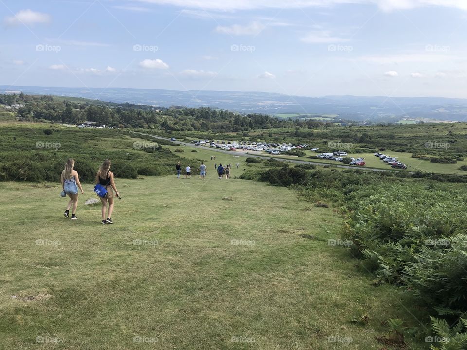 Visitors leaving Haytor on a remarkable job done, to view this famous rock on an historical day the hottest August bank holiday Monday ever.