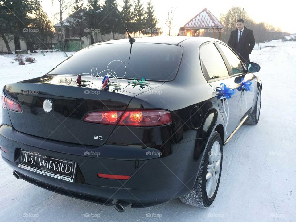 Our beloved Alfa Romeo car dressed in flowers for wedding ride