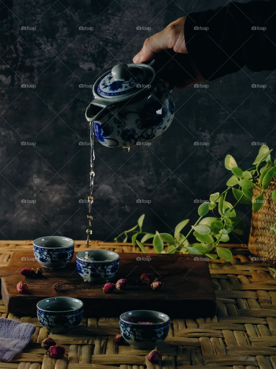 White Ceramic Chinese style Teapot pouring Chinese tea in Ceramic cup. White Ceramic Chinese style Teapot set for tea break time