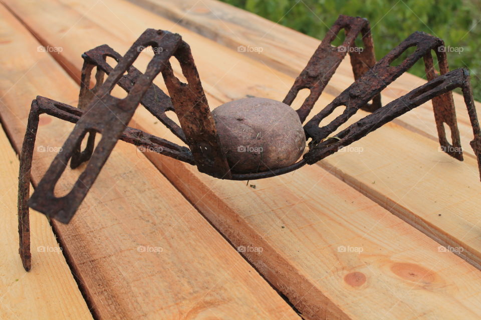 This is stone and iron spider sculpture