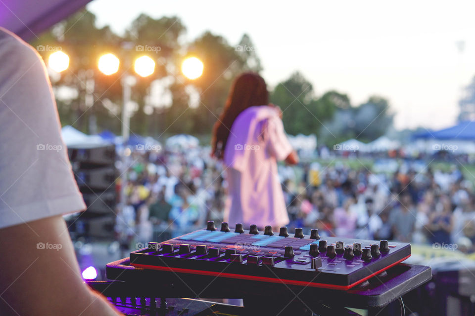 DJ and artist perform for a festival. 
