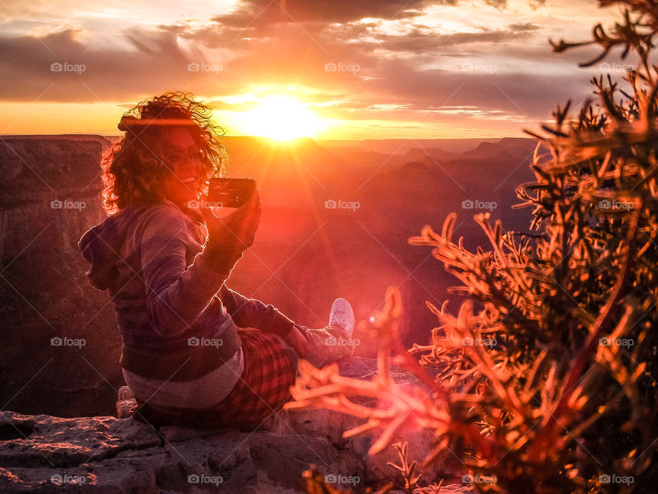 Take a photo of me. Grand Canyon magic hour girl asking to take a picture of her during the sun set on her cera