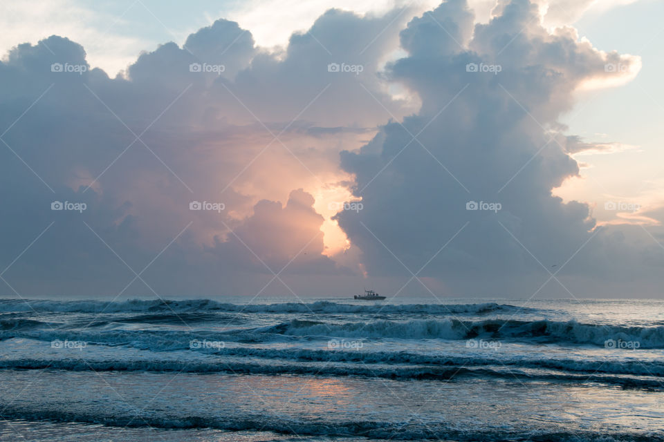 Ship in the sea against cloudy sky