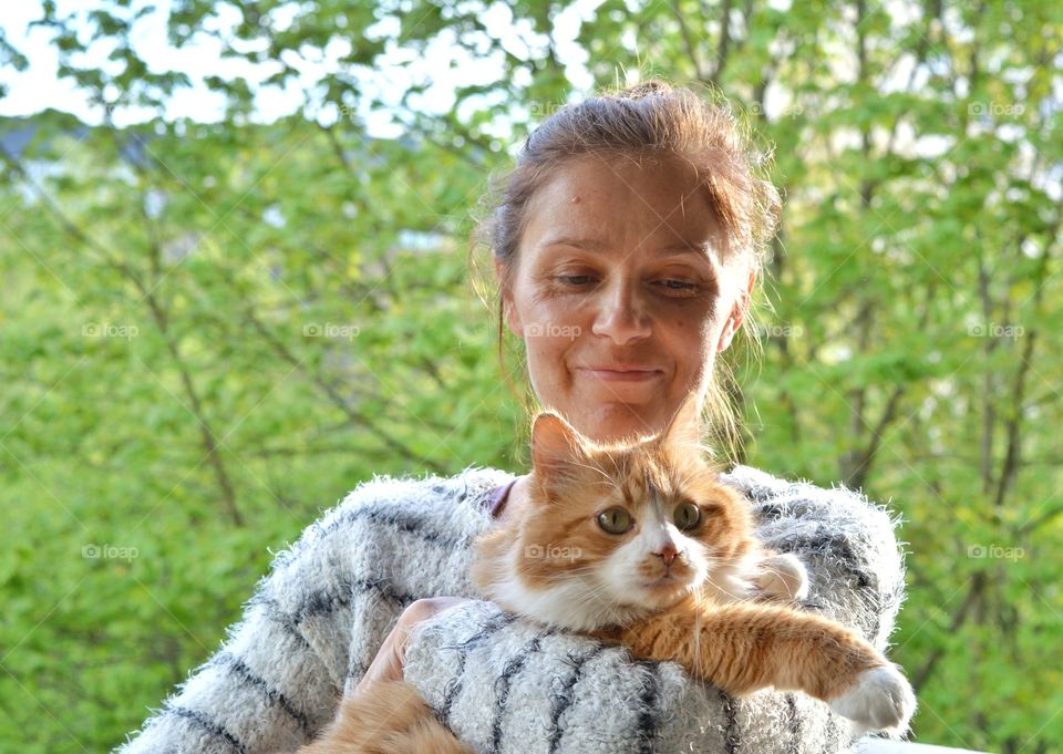 woman and ginger cat green background, family relaxing, love pet