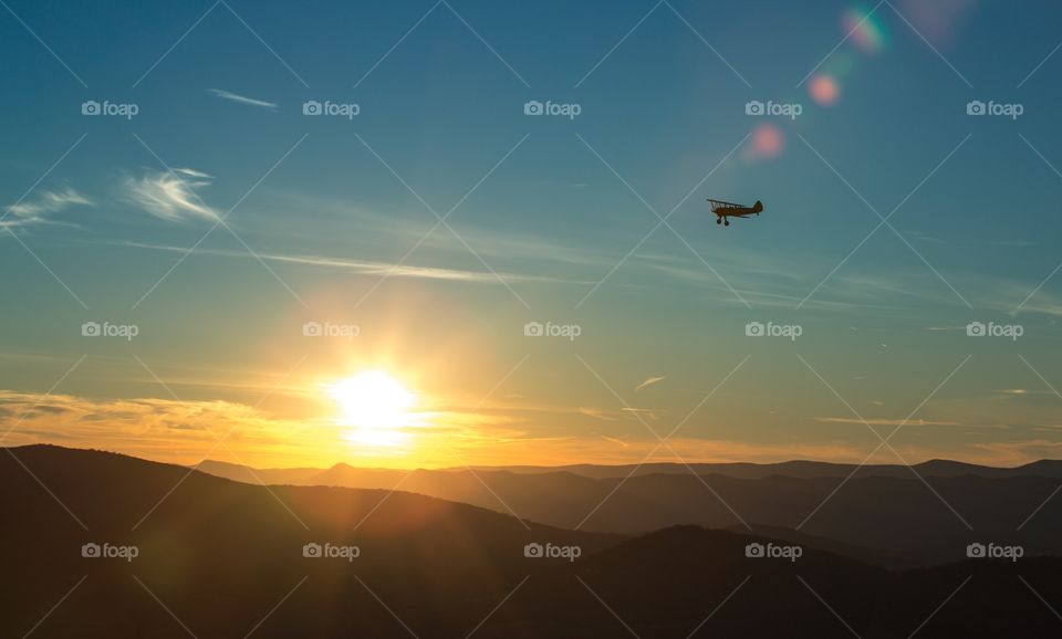 Airplane flying into the sunset