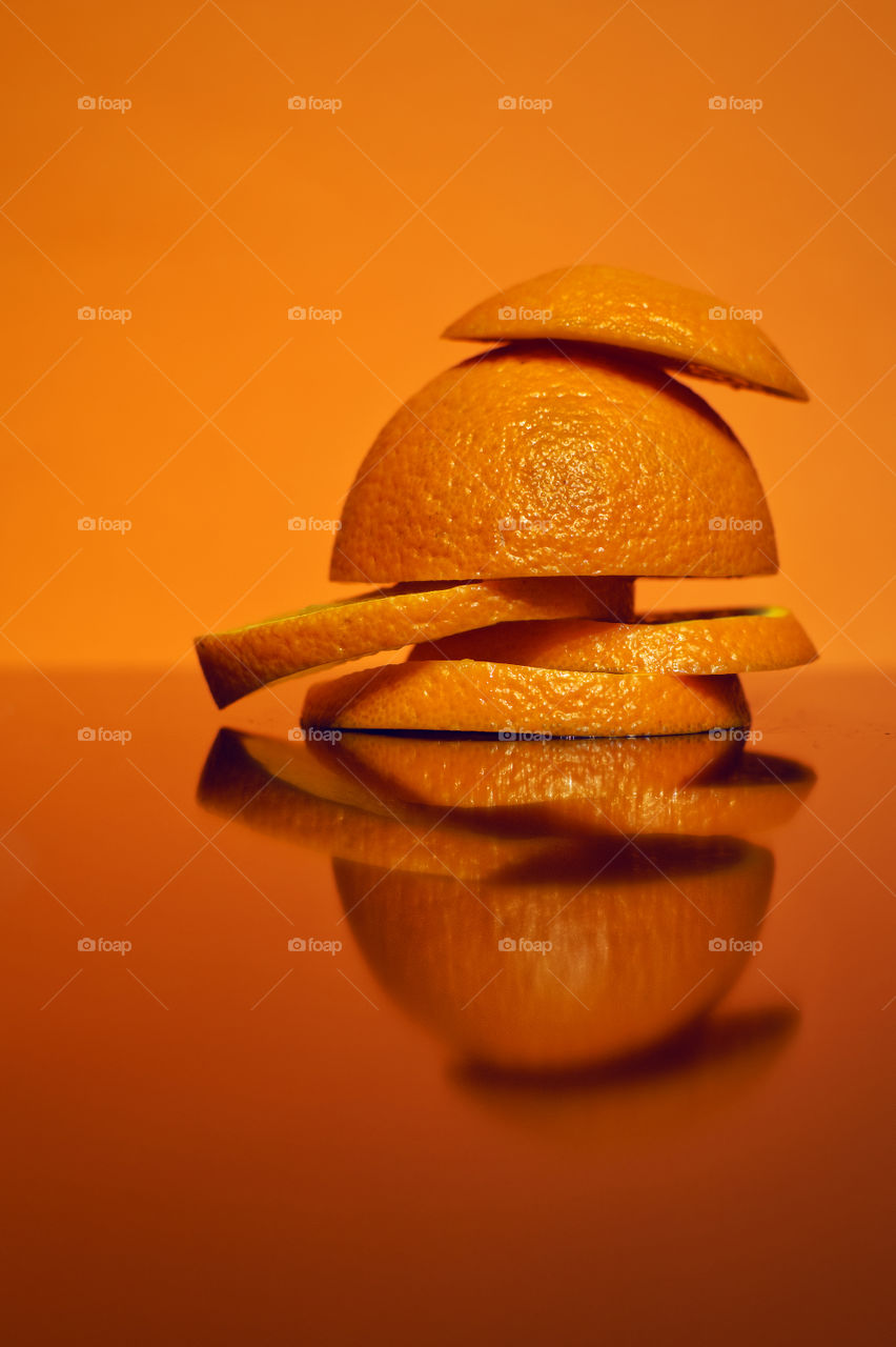 Orange slices reflected in glass surface