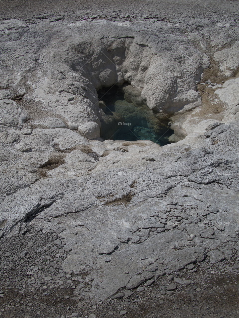 Stunning geology in the unique landscape of Geyser Hill in Yellowstone National Park on a sunny summer day. 