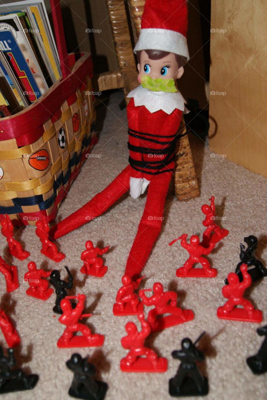 Captured. Elf on the Shelf is captured by tiny soldiers.