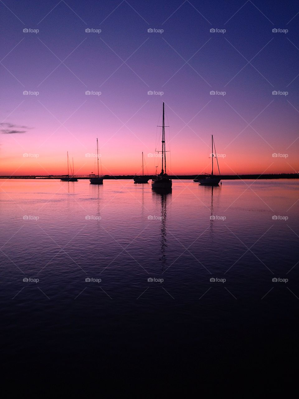 sailboats silhouette in a sunset in Portugal