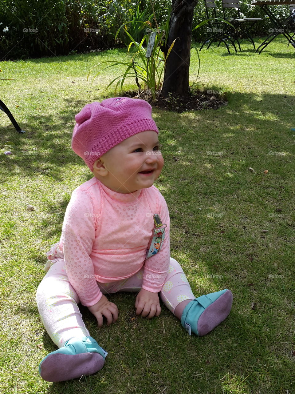 Smiling baby sitting in grass
