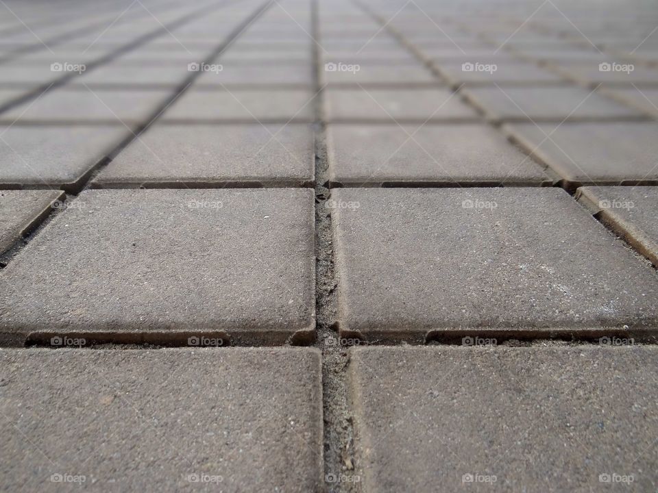 Symmetrical pavement tiles