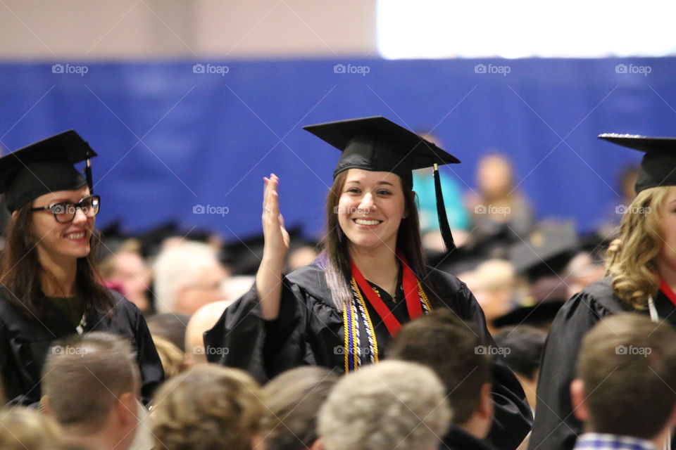 Happy woman wearing graduation hat