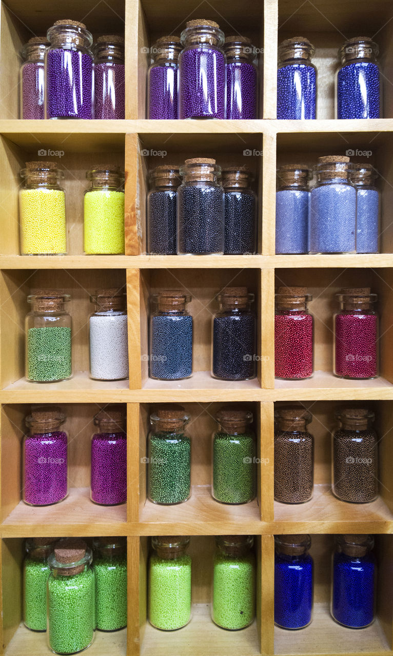 Decoration dust in small glass bottles. multicolored dust in glass bottles
