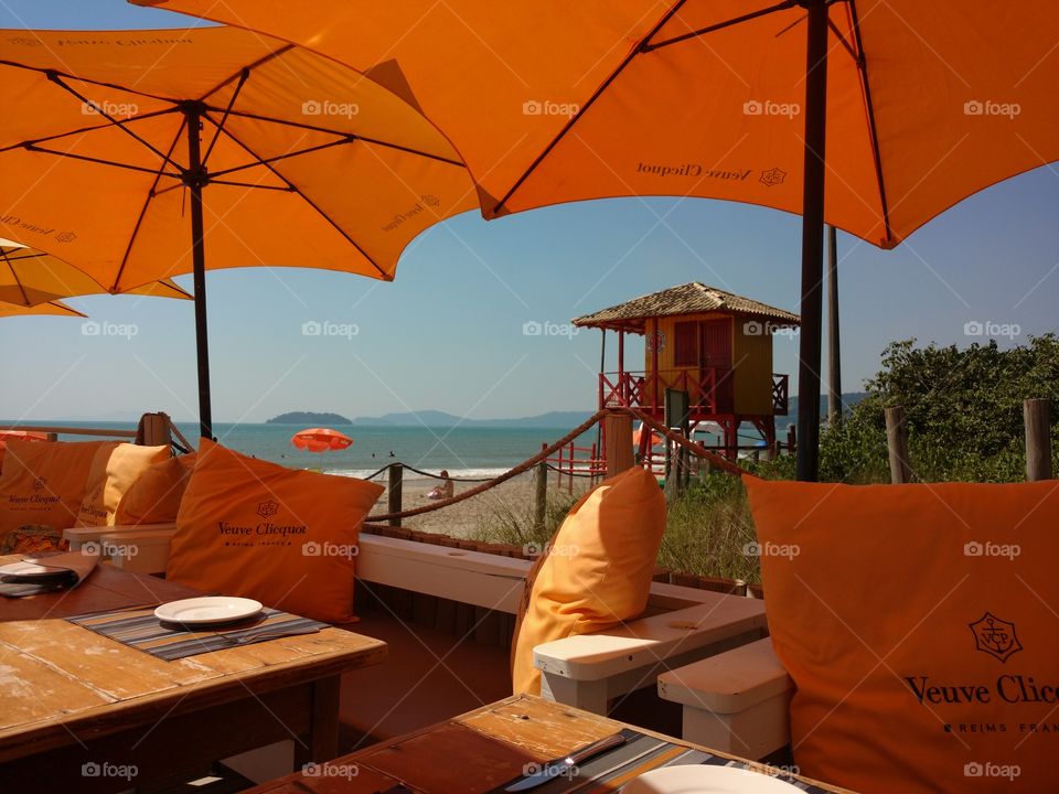 Orange umbrelas by the sea