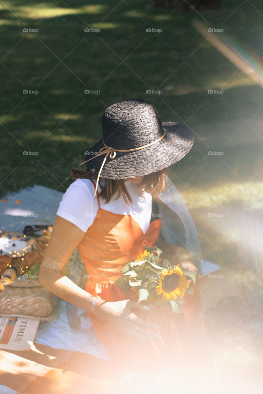 Picnic time, sunny weather, autumn, sunflowers, girl with hat
