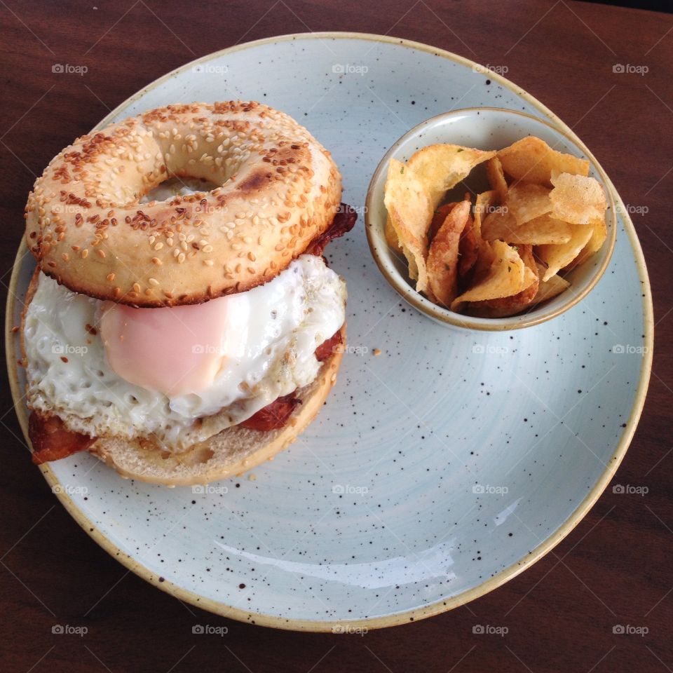 Breakfast bagel. Fried egg breakfast bagel