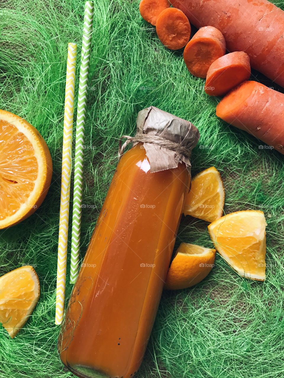 Close-up of juice bottle and carrot slice