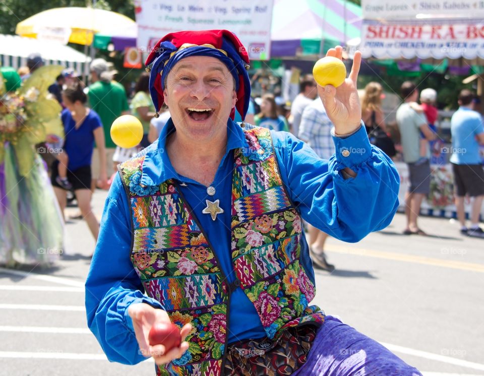 Juggler. Street performer juggling at a festival. 