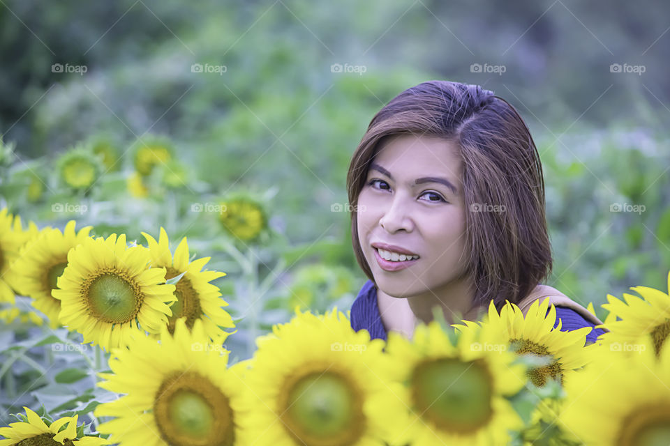 Woman in Yellow Marigold flowers garden or Tagetes erecta in garden