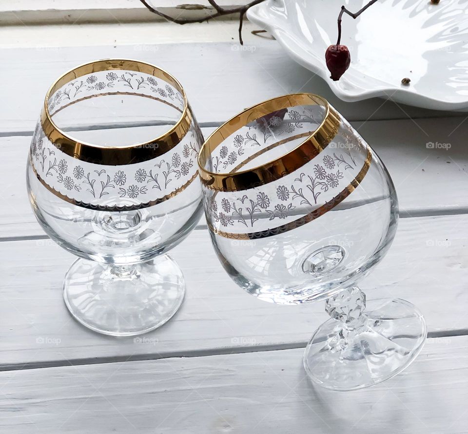 Two crystal glasses for brandy with golden ornament