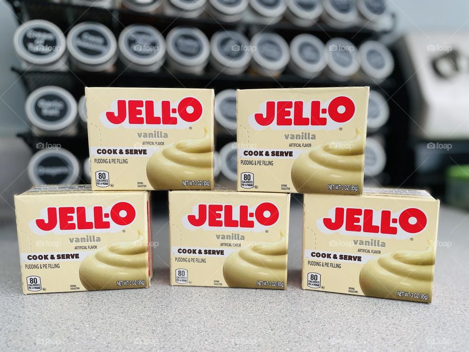 Jell-o pudding stacked on counter, lots of vanilla jell-o pudding, making sweet treats for kids 