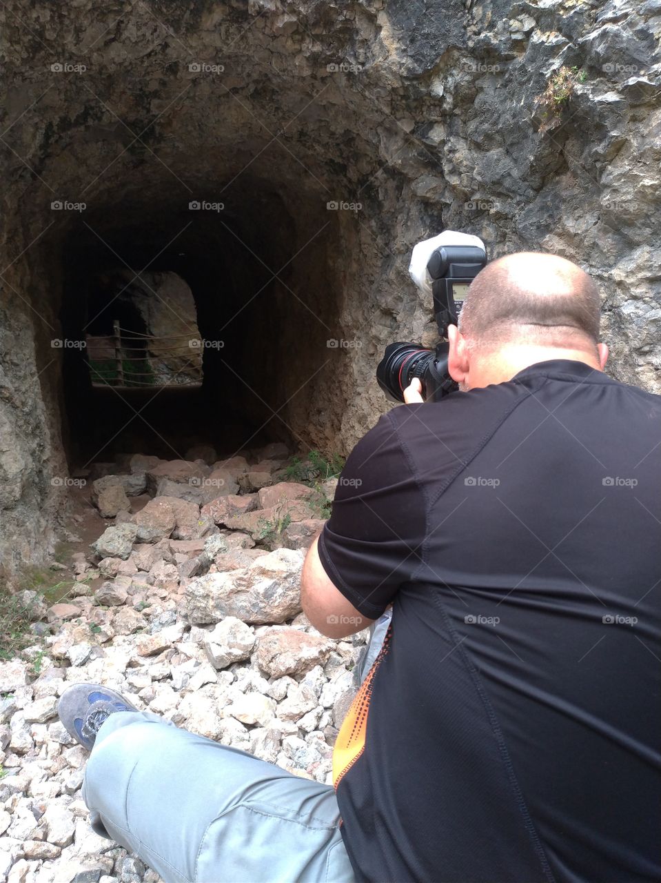 Un fotógrafo  fotografiando la entrada de una cueva