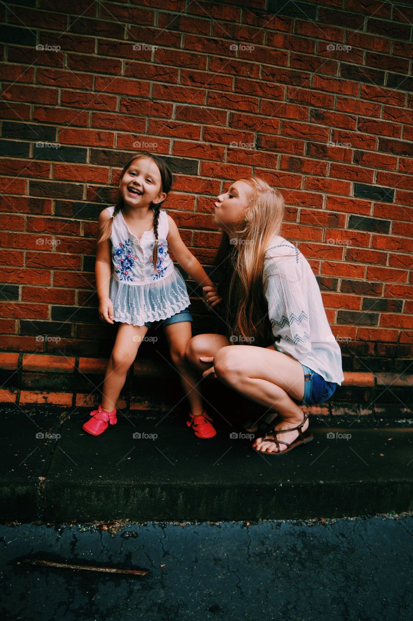 Woman pouting towards a happy daughter