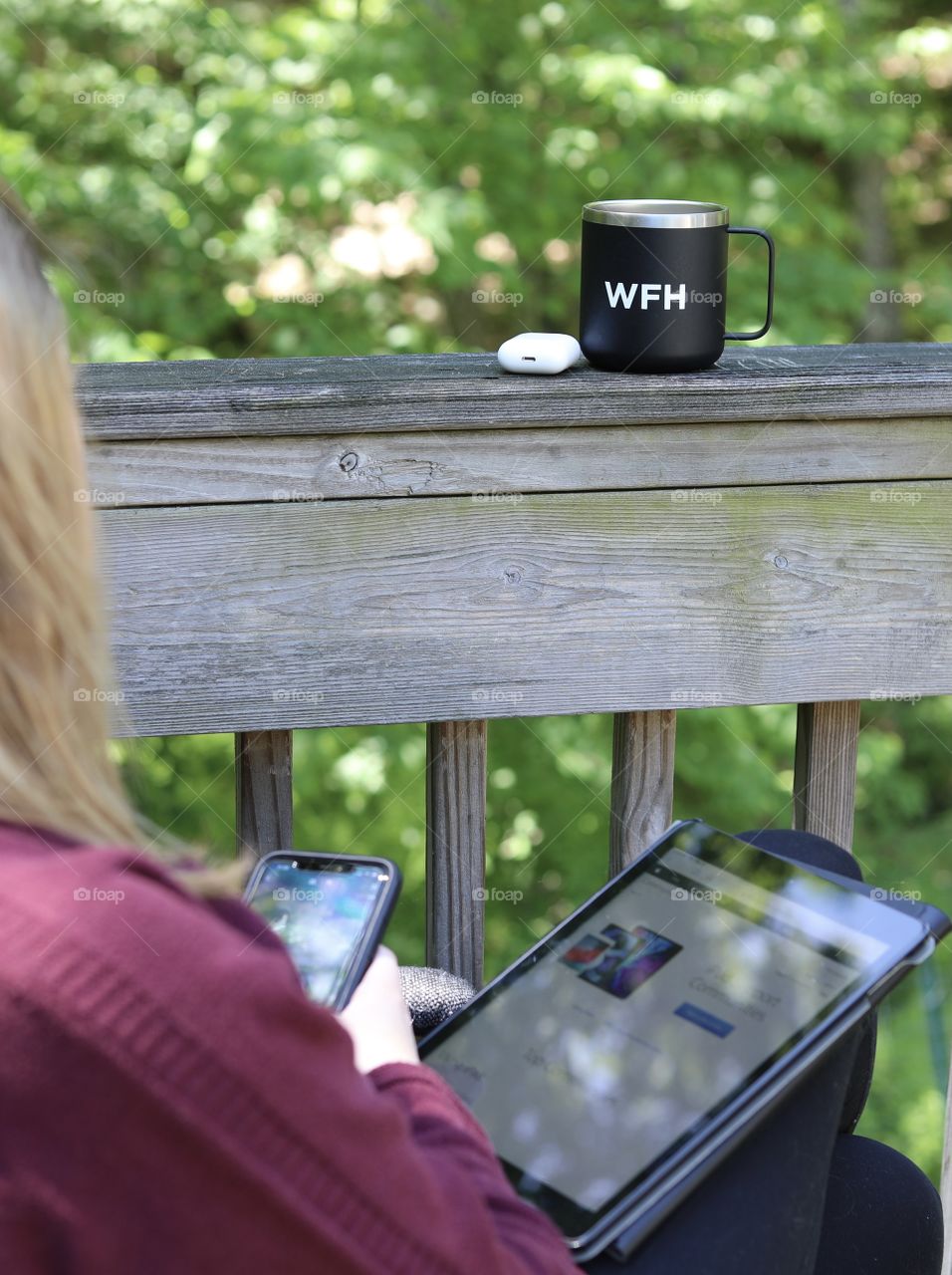 Woman using iPhone 11 Pro Max and a Gen 7 iPad with Gen 2 AirPods and “Work From Home” Coffee Cup