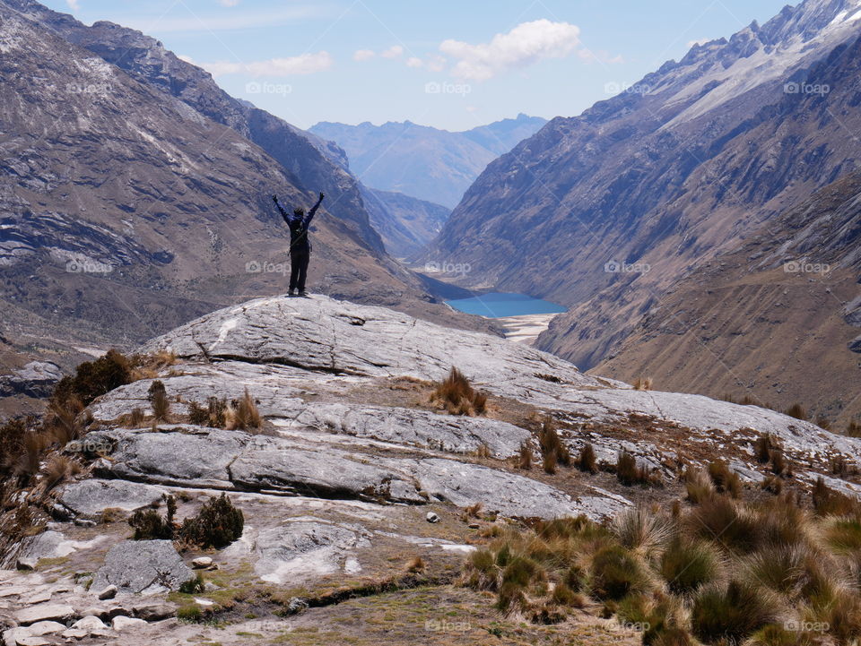 A woman hiking in high mountains enjoying the view