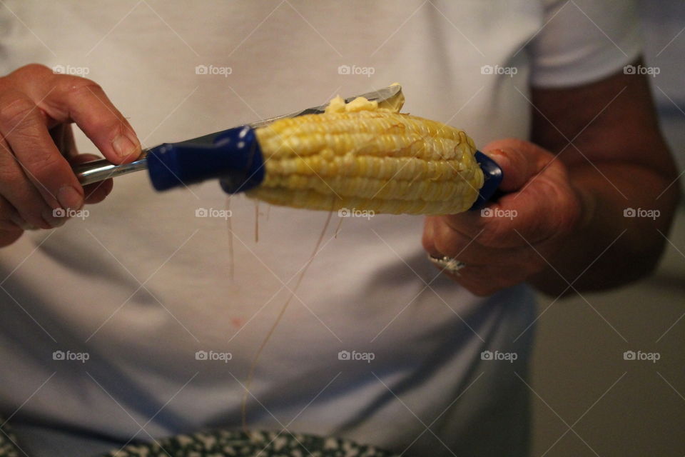 putting butter on the corn