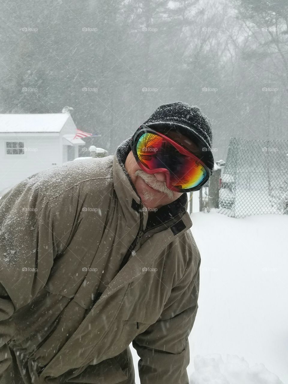 Shoveling snow, goggles, smiling  man