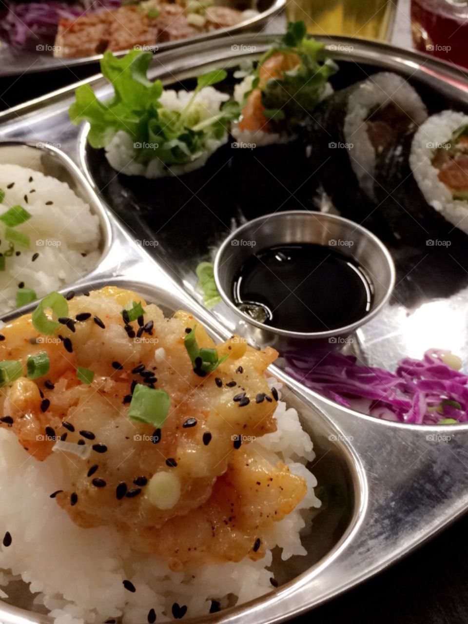 Sushi and shrimp platter in metal tray 