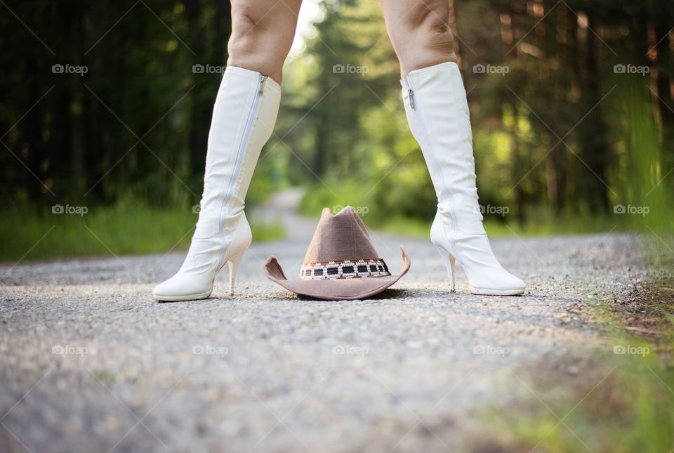 Woman with a hat on road