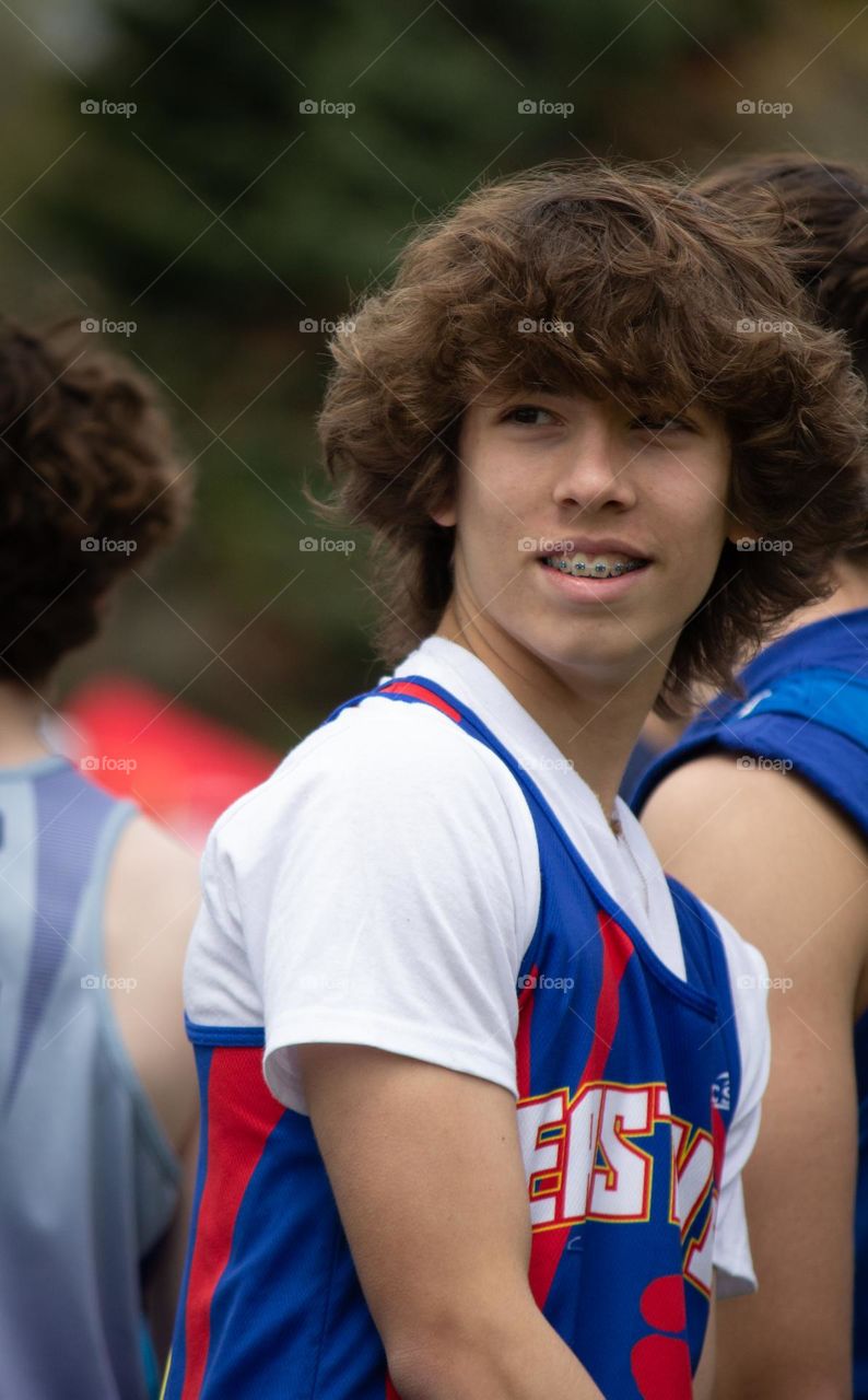 Teenage boy looking around at start of race