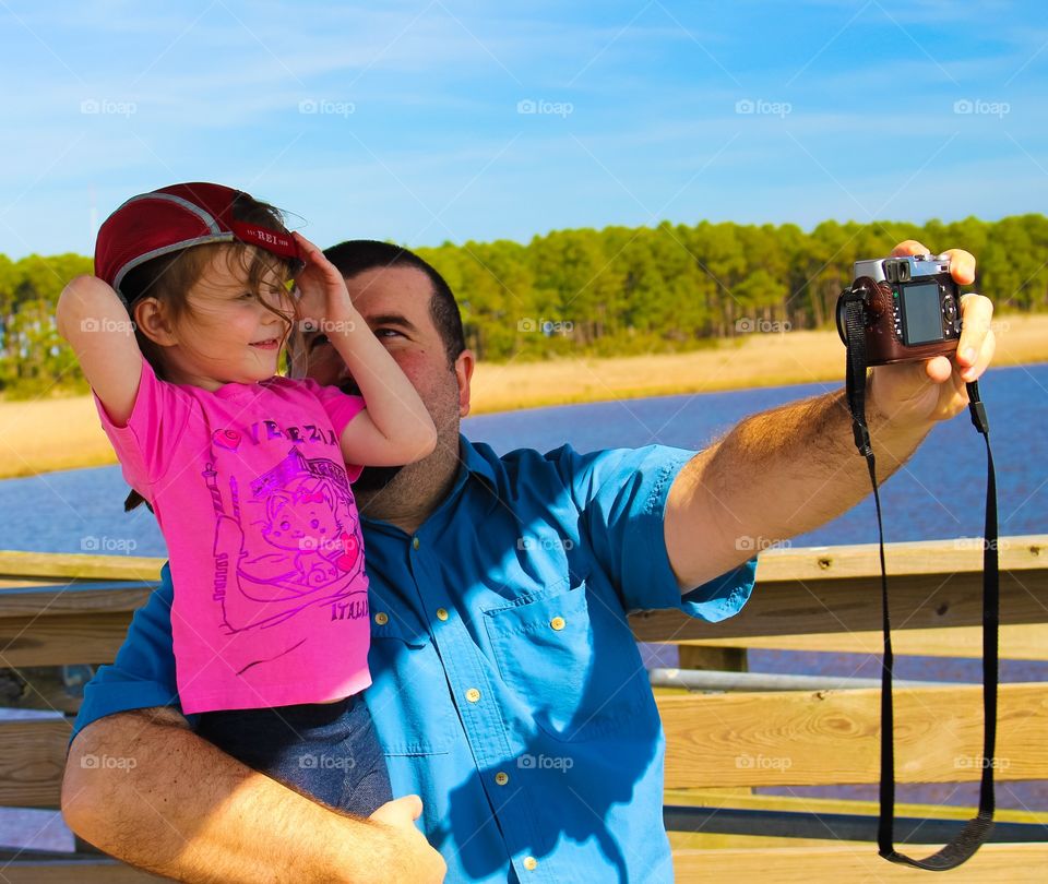 Father photographing with his daughter