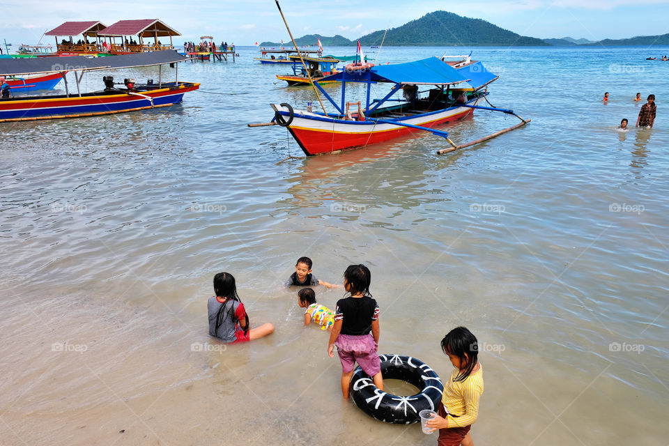 playing in the sea of Klara Beach, South Lampung, Indonesia