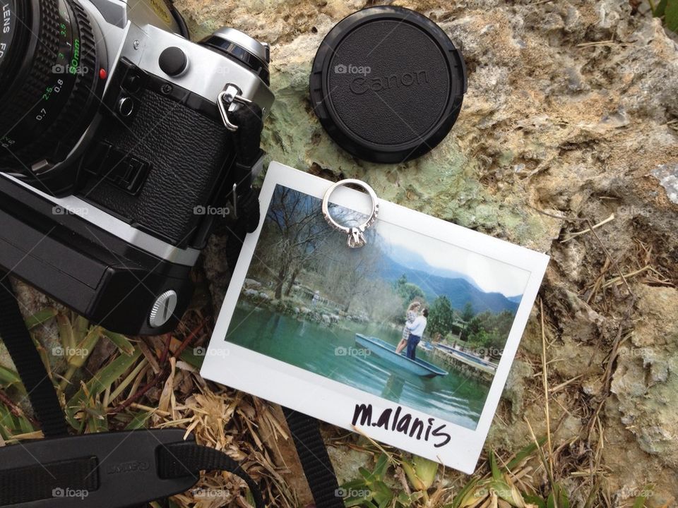 Wedding ring, polaroid and camera