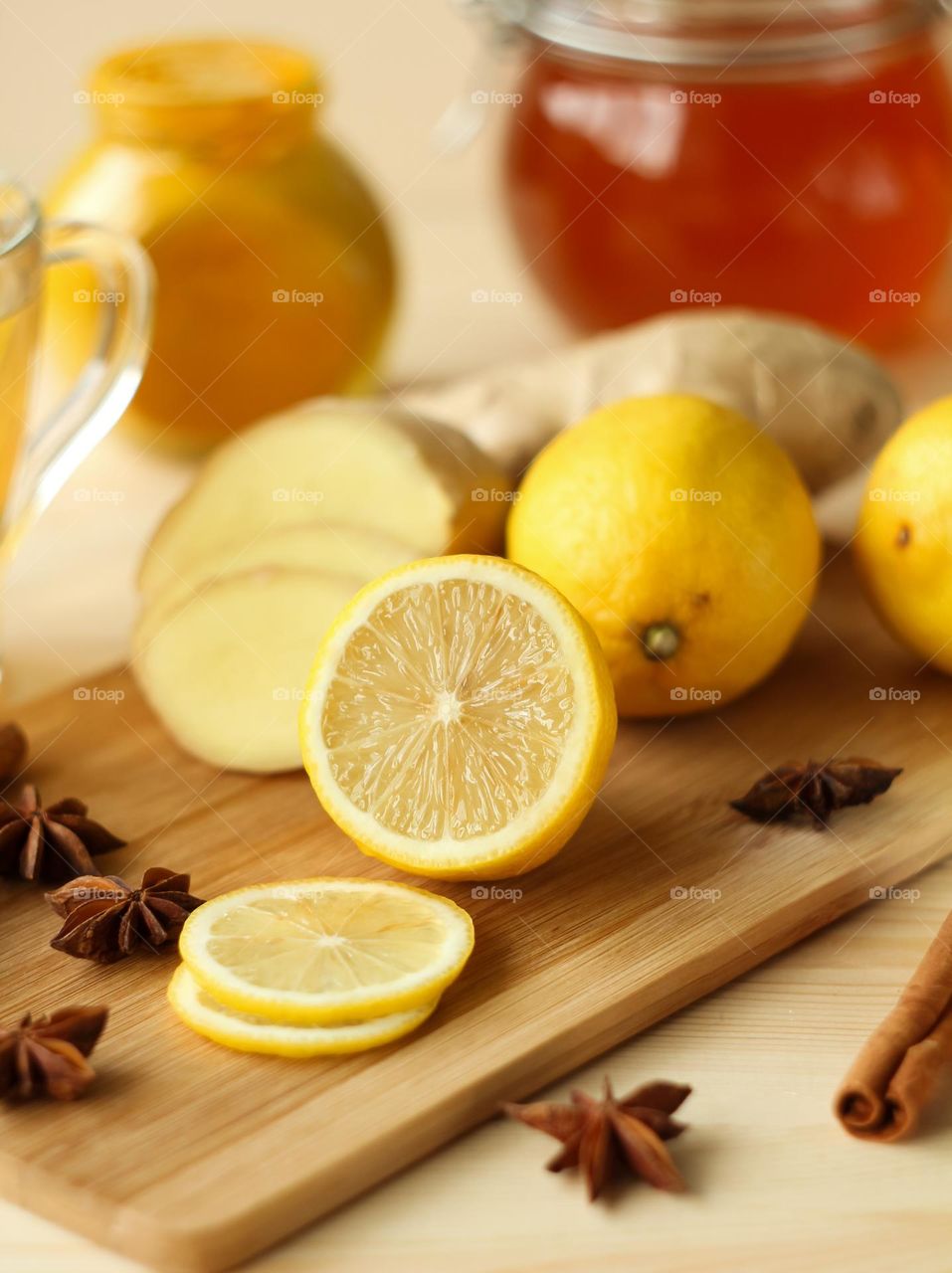 Half a lemon and ginger on a wooden board