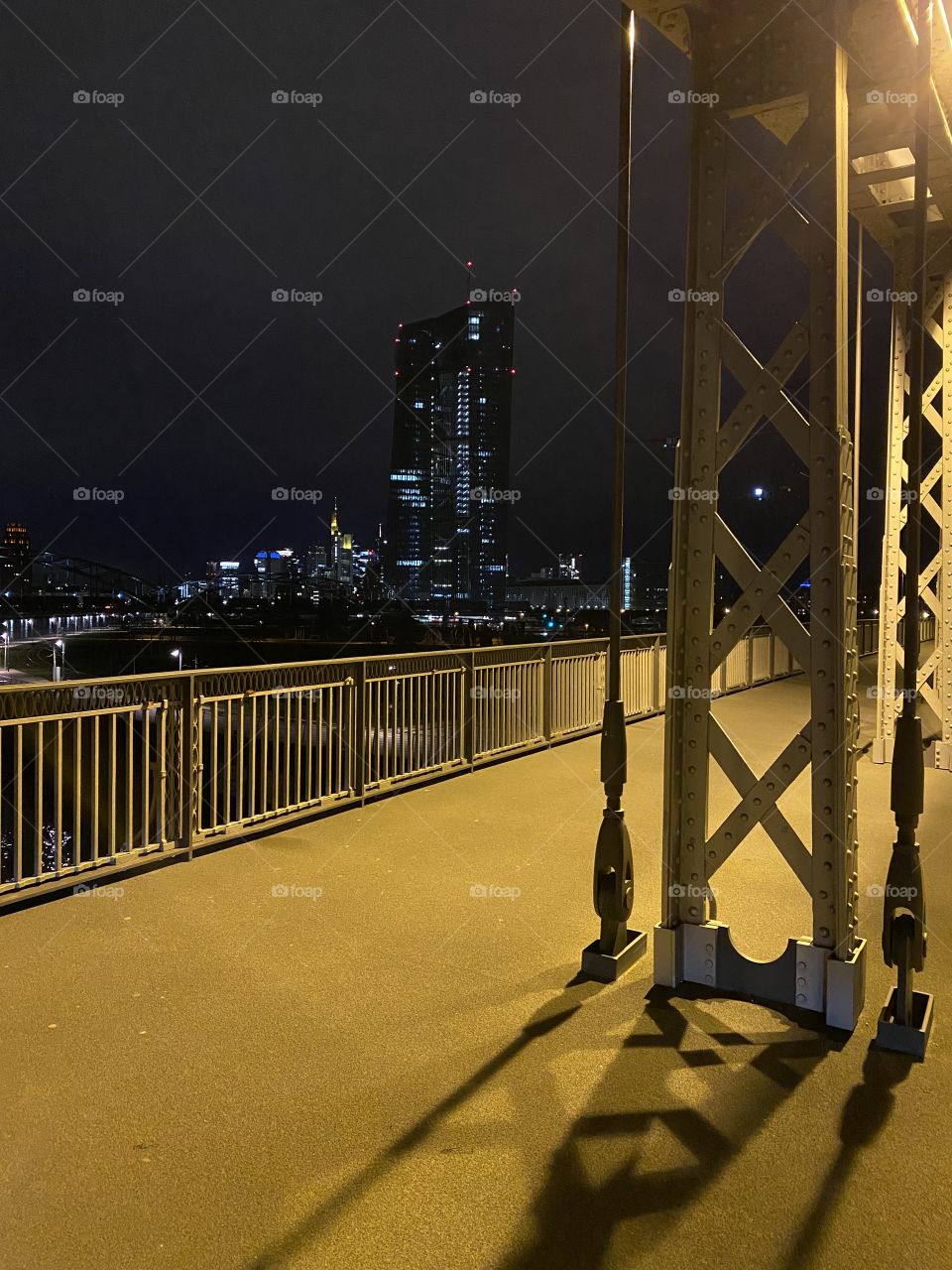 Bridge at night with Frankfurt skyline as background 
